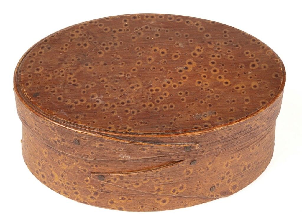 The spotted umber and yellow dabbed decoration of this New England bentwood pantry box was original and helped drive the $11,950 price, paid by a Virginia collector. White Collection ($1/1,500).