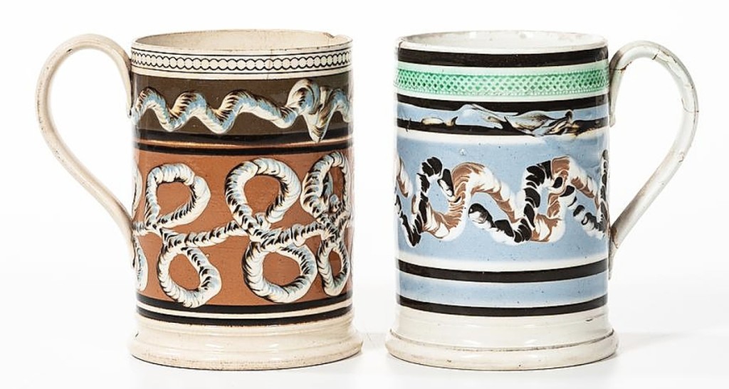 The numerous pieces of mocha included these two slip-decorated 1-quart mugs. Made in England, dating to the early Nineteenth Century, the two went out for $1,188.