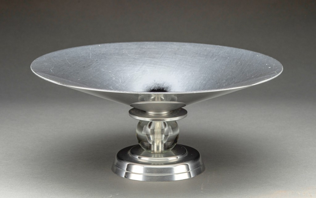 Stratford compote manufactured by Aluminum Company of American (Alcoa), designed by Lurelle Guild (American, 1898-1986), circa 1934. Aluminum, glass. New Orleans Museum of Art, Gift from the George R. Kravis II Collection, 2019.8.24. ©Alcoa Inc.
