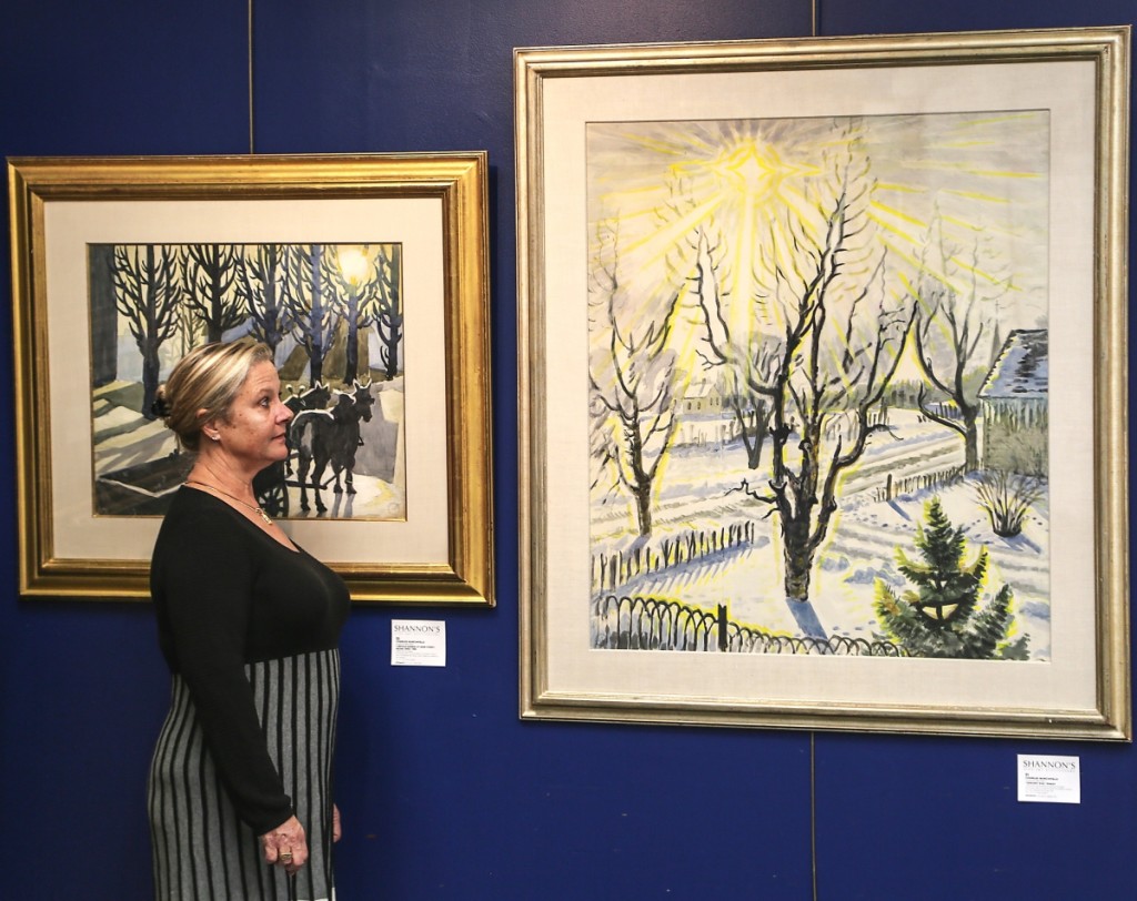 Managing partner Sandra Germain looks at her top lot, Charles Burchfield’s watercolor on paper “January Sun,” which sold for $380,000. After completing the work’s right side through the sun’s left edge in 1948, the artist returned to it nine years later to add more space to the left side, allowing the sun’s beams to shine in all directions equally.