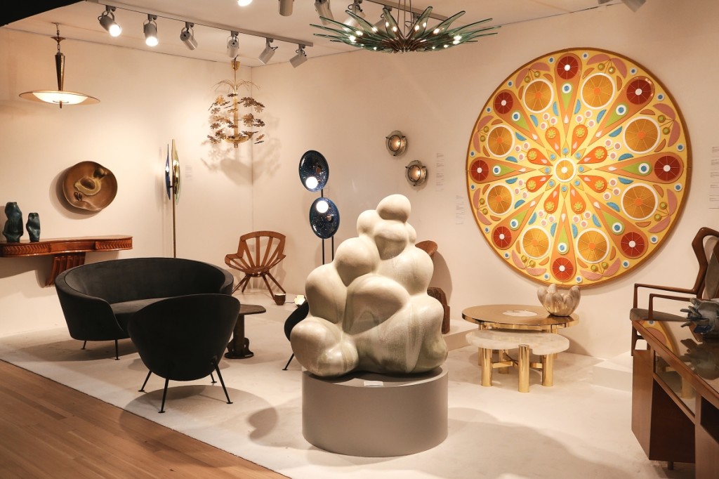 Paul Donzella of Donzella Galleries said the energy of the show was buzzing.  Its stand featured design titans, including Gio Ponti, Paavo Tynell, Max Ingrand and Ico & Luisa Parisi.  The large artwork on the back right wall is by contemporary artist Chris Bogia, 