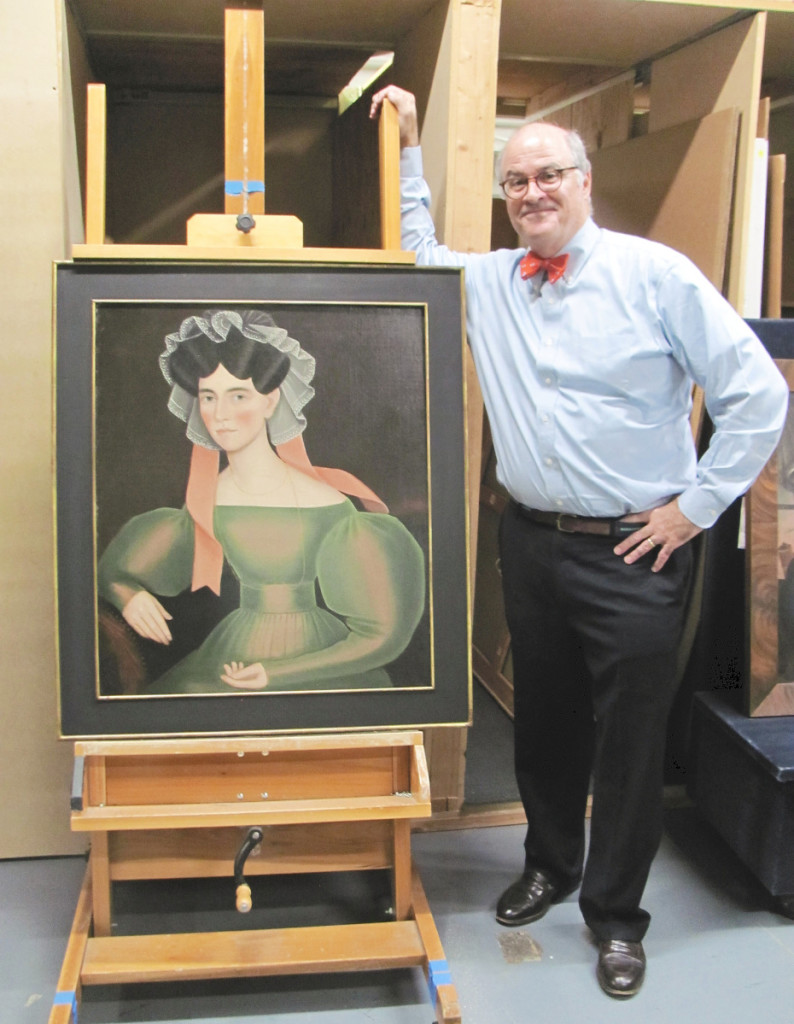Christie’s deputy director John Hays with one of the top lots in the sale, “Woman with Pink Ribbons” by Ammi Phillips (1788-1865).