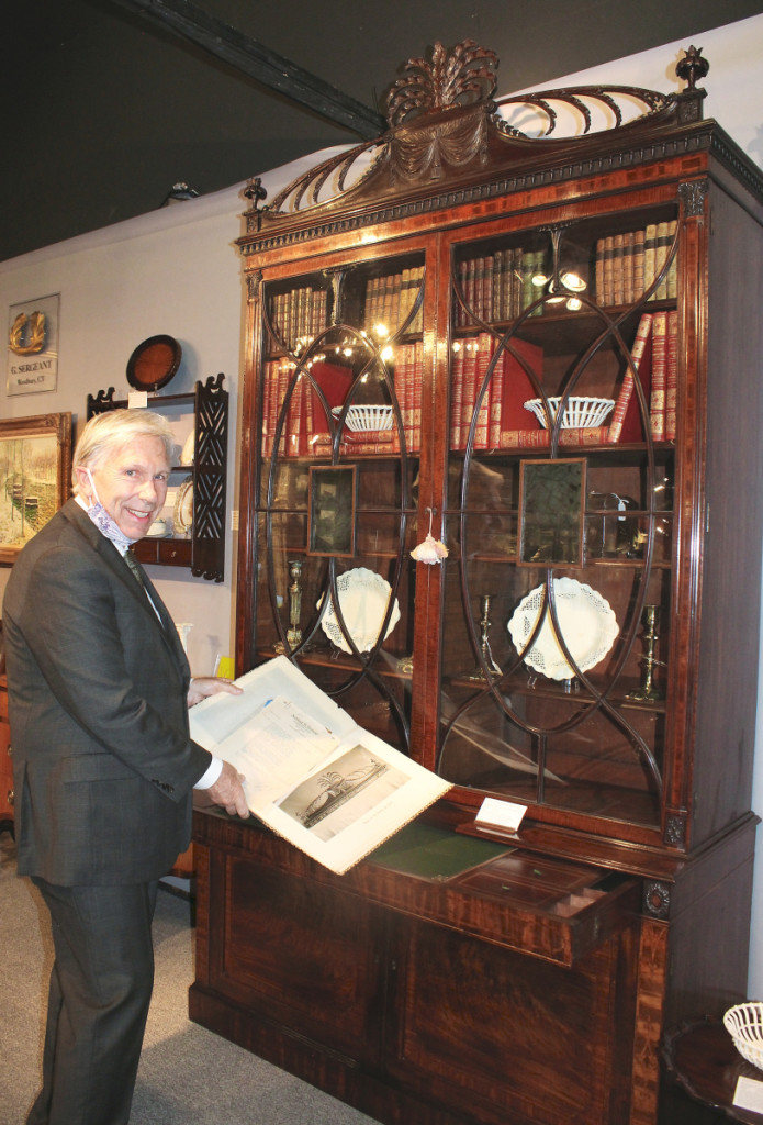 English furniture dealer Gary Sergeant with a Thomas Sheraton designed desk and bookcase that was accompanied by an early Twentieth Century bill of sale. G. Sergeant Antiques, Woodbury, Conn.