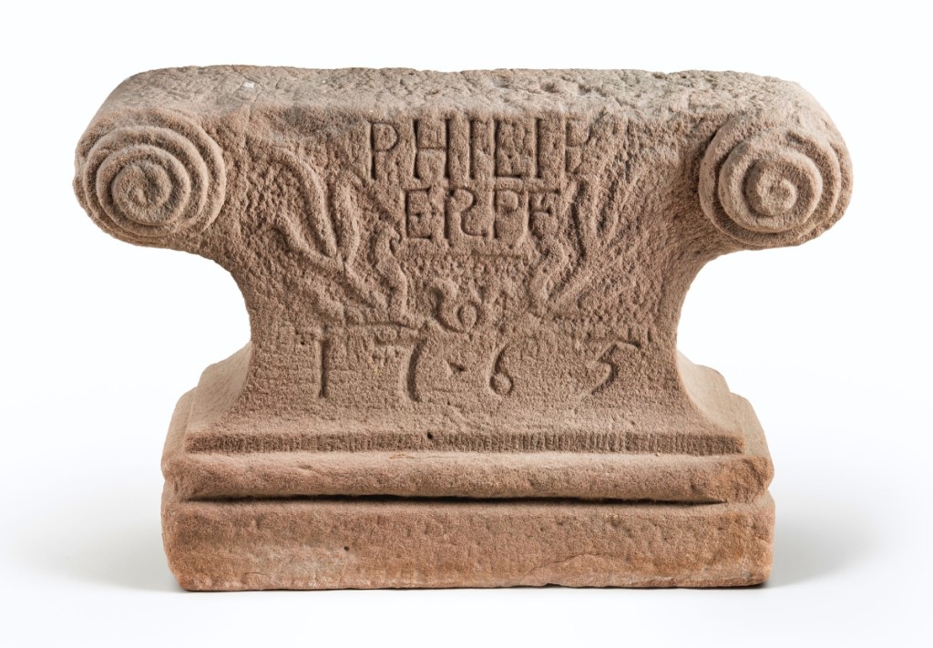 This carved stone foot, made to hold up the front end of a five-plate stove, was made for the house of Philip Erpf, a storekeeper in Schaefferstown. His name and the date of 1765 are inscribed above and below a relief-carved flowering vine. Similar carving is found on Pennsylvania German gravestones and the datestones of houses. 				                 —Gavin Ashworth photo