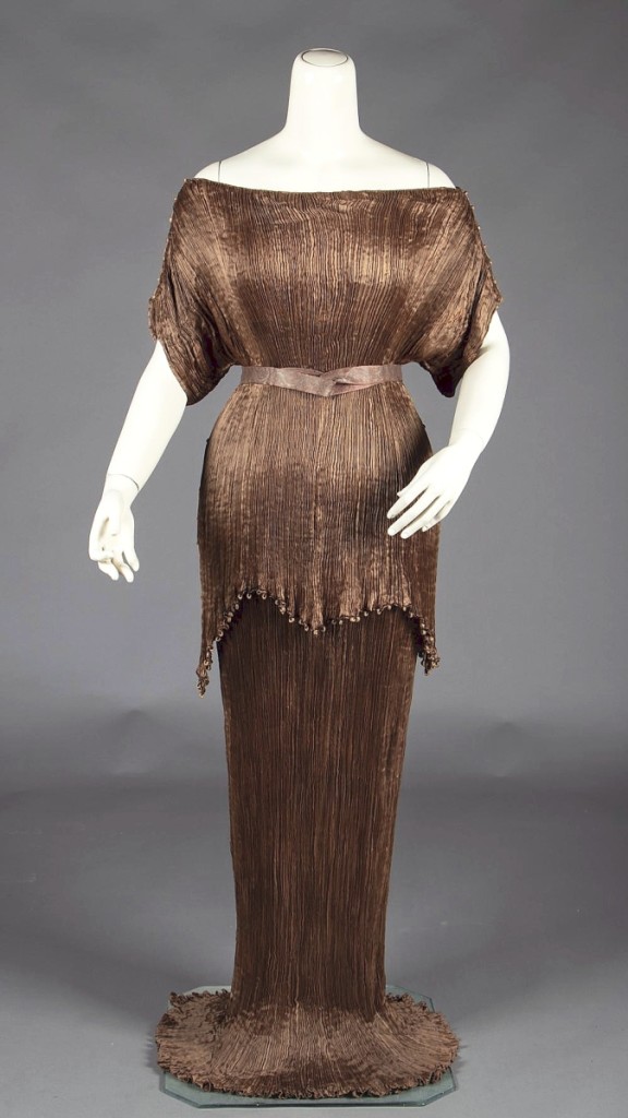 This Mariano Fortuny bronze pleated silk peplos gown dated to the 1920s or 1930s; having descended in the family of the original owner and retained its original box. It was chased by both institutional and private interest, closing at $7,500, the second highest price in the sale ($4/6,000).