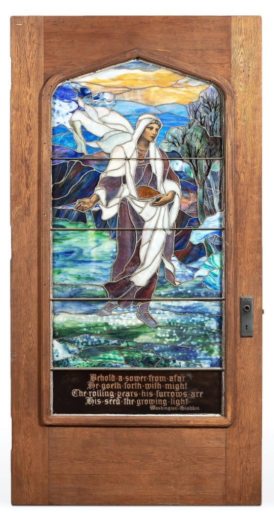 This Tiffany Studios “The Sower” Favrile glass door sold for $51,425. Circa 1920s, the leaded and plated Favrile glass panel in oak door depicted a female figure as the seed sower.