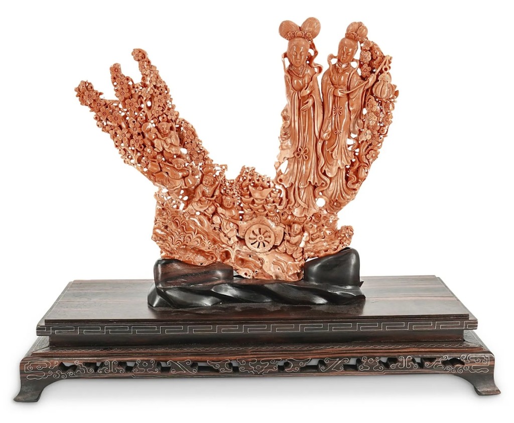 The sale was led at $29,940 by a carved coral figural group depicting Immortals amid cherry blossoms and village people. It measured 17 inches high on stand.