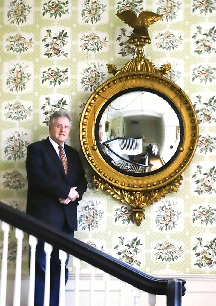 John McInnis stands in to demonstrate the massive scale of the Nathaniel Bowditch Family convex mirror, which went out at $13,090. The 76-inch-tall mirror was purchased by Bowditch to furnish his residence in Salem, Mass., at 9 North Street, a historic home that stands today as the Nathaniel Bowditch House and serves as the headquarters for Historic Salem.