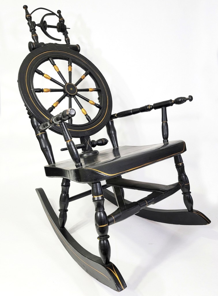 Rocking chairs and spinning wheels are two iconic emblems of ancient American history.  This late 19th century example combines the two.  Private collection.