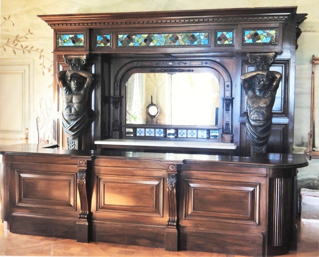 Carved mahogany stained glass bronze bar from a mansion home in Newport, R.I., made in Europe, Nineteenth Century, 10 feet tall by 13 feet 6 inches wide, was bid to $19,200.