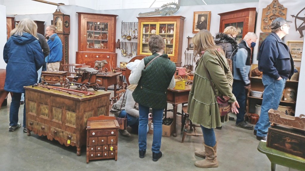 Dealer booths were packed as buyers peruse folk art and antiques, shown here in the booth of Greg K. Kramer & Co., Robesonia, Penn.
