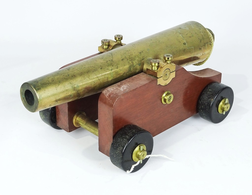 An early brass with wood carriage signal cannon patented in January 1883 and manufactured by Strong Fire Arms Co., New Haven, Conn., shot to $3,068.