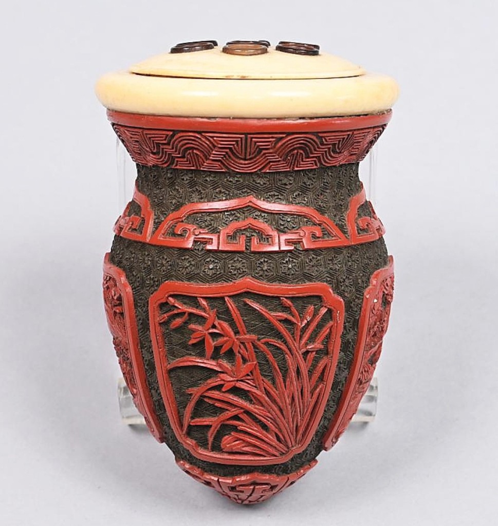 The selection of Asian items included a carved red and black cinnabar censer. The relief carving had two panels of mountain and river landscape scenes alternating with two panels of bamboo and a fruiting plant. It sold for $8,750.