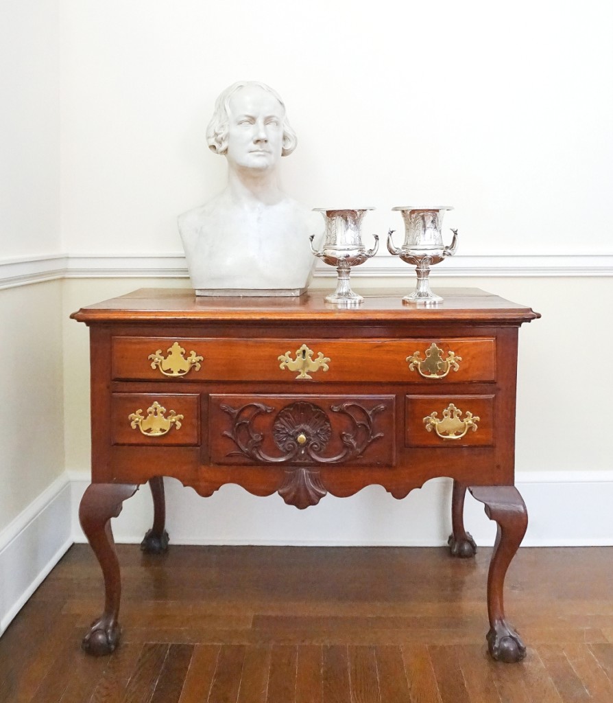 Selections from The Christine Biddle Wainwright   Collection, American Paintings, Furniture, Silver & Decorative Arts, to be offered at Doyle May 4. Clockwise from left: plaster bust of Nicolas Biddle by Luigi Perisco ($200/400); pair of American Federal silver twin-handled footed vases of historic importance, made by Thomas Fletcher and Sidney Gardiner, Philadelphia, 1832, engraved “Thomas Biddle to His Brother James August 26, 1831” ($7/10,000); and Chippendale mahogany shell-carved dressing table, Philadelphia, circa 1775 ($15/25,000). Photo courtesy Doyle.