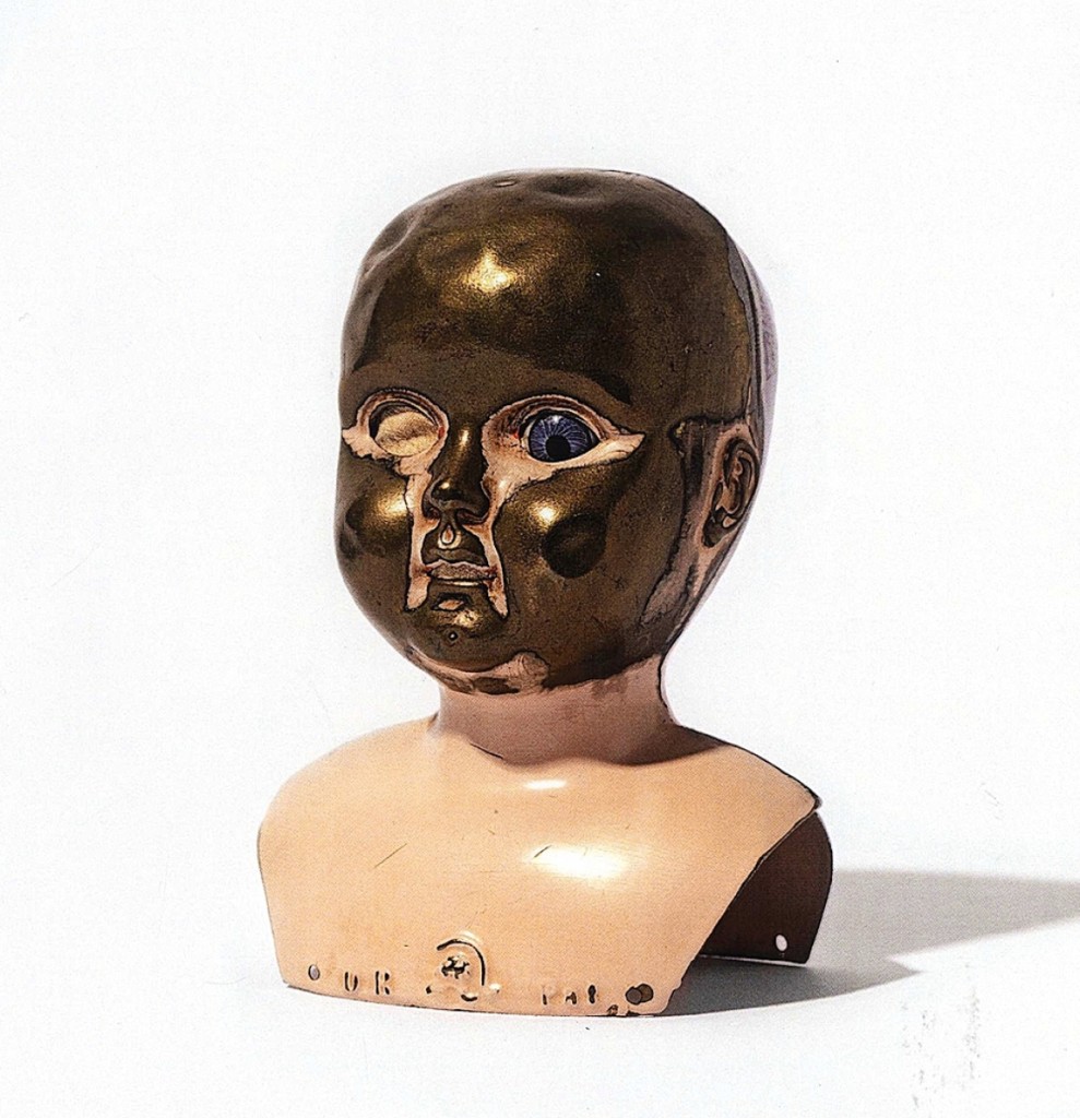 The surface of this metal doll head has been compulsively worn away by hand, suggesting one of its owners may have struggled with emotional issues and took comfort in stroking the head of a favorite toy. Eric Oglander.