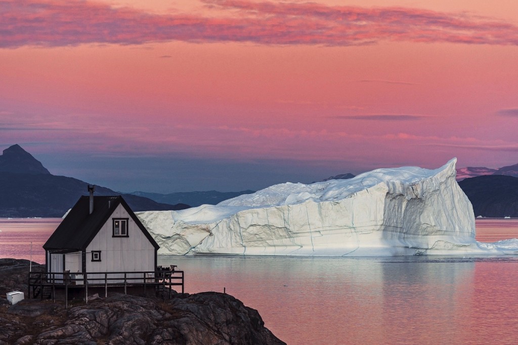 The magenta sunset colors the Sound as if a watercolor painting. Uummannaq Fjord, 2016.            —Denis Defibaugh photo