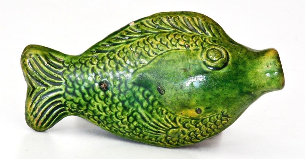 This Moravian green glazed redware fish flask, made in Salem, N.C., is one of the smallest sizes known (4½ inches long) and had provenance to the Stradlings. It splashed out at $28,800 ($8/12,000).