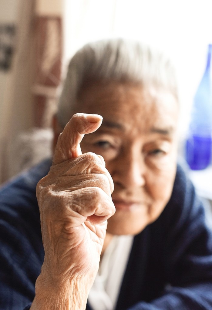 Dorthe Simionsin shows her deformed finger caused by a life of sewing seal skins. Uummannaq, 2016.   —Denis Defibaugh photo