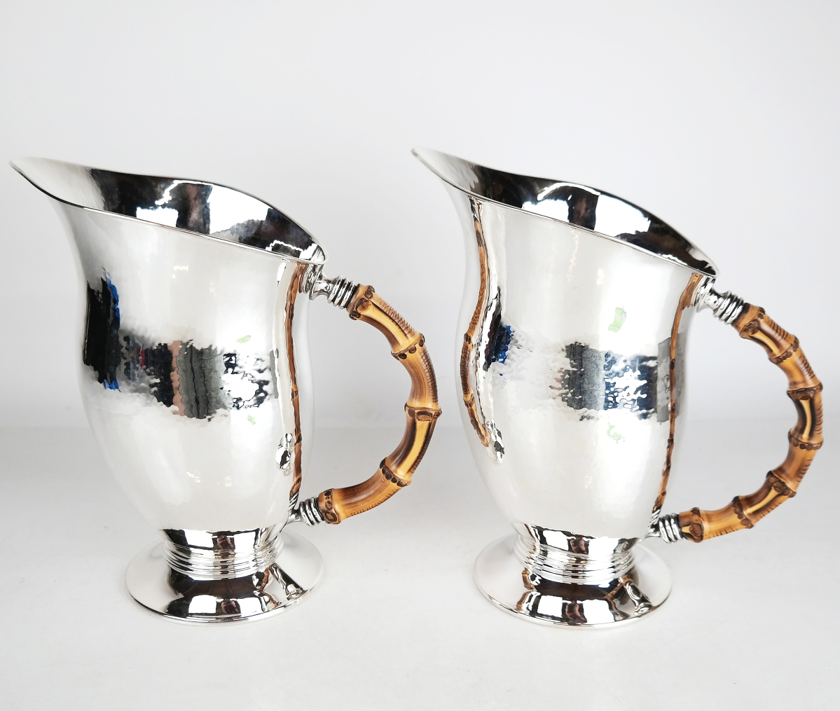 Pair of Buccellati silver water pitchers, Italian sterling silver water pitchers by Buccellati, with bamboo handles